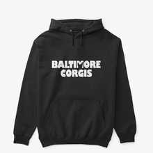 A black hoodie that has a white Baltimore Corgis logo.